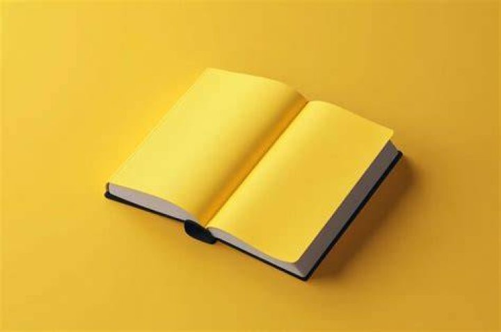 an open book with yellow highlight on the page and someone's hand