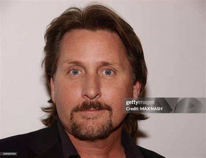 Director Emilio Estevez and his wife pose for pictures during the