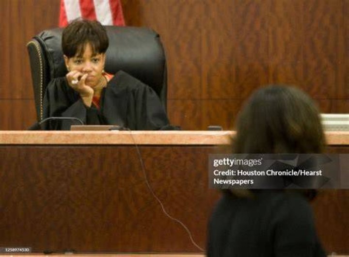 District Court Judge Belinda Hill, left, listens to defense attorney