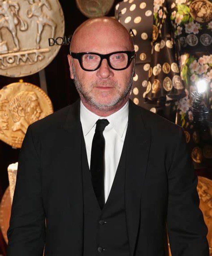 Domenico Dolce with his arm around Sutton Stracke in front of her boutique establishment.
