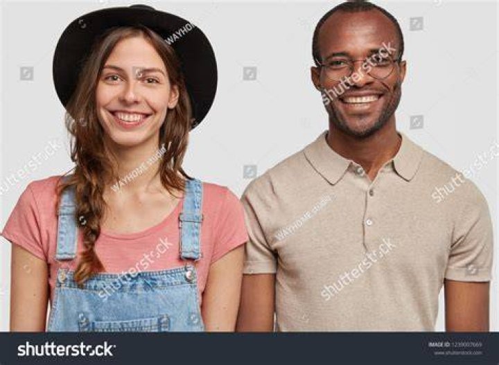 Horizontal shot of two, multiethnic men bumping fists. The photo is