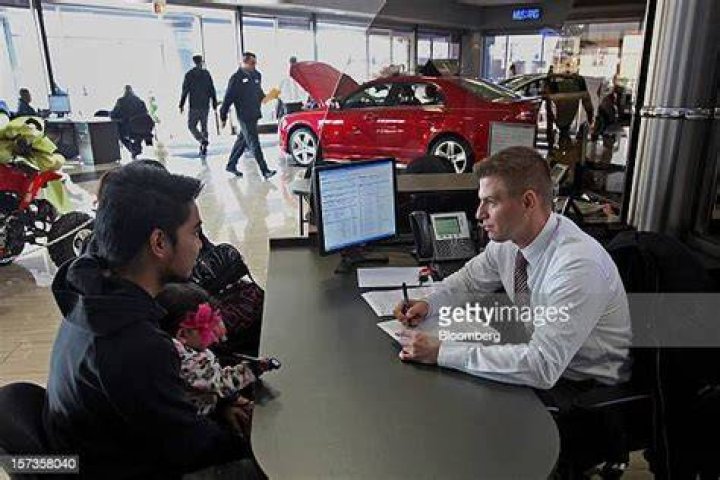 Sales representative Rafal Kubus, right, assists customers at Golf